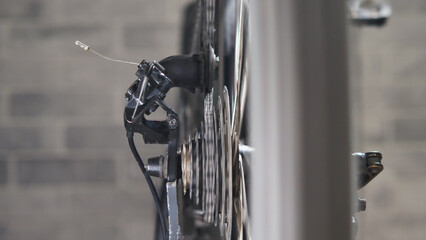 Greased rotating wheel of a bicycle. Focus on mountain bike drivetrain. Repair and diagnostics of a bicycle in the workshop.