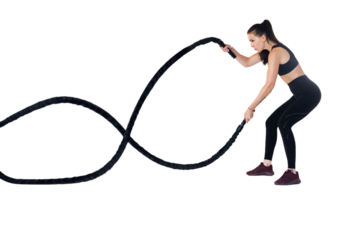 Woman doing exercises with battle rope. Photo of muscular model in sportswear isolated on transparent