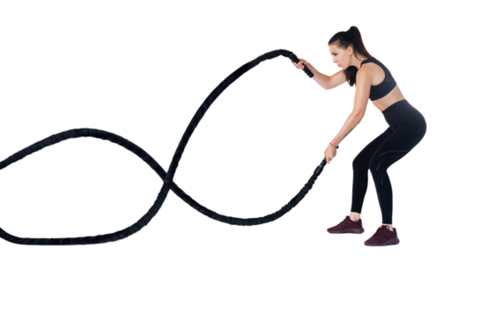 Woman doing exercises with battle rope. Photo of muscular model in sportswear isolated on transparent