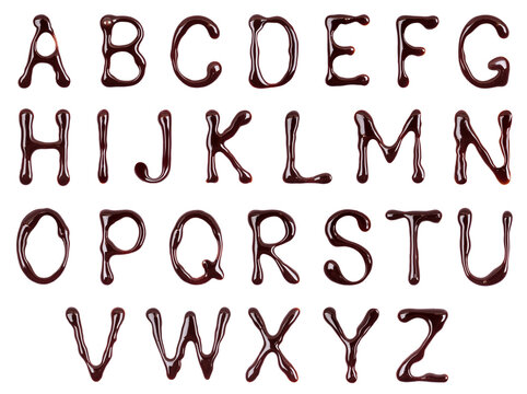 Glossy large letters of the Latin alphabet made of melted chocolate isolated on a white background