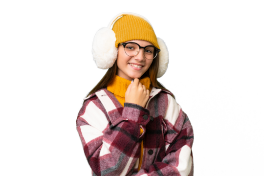 Teenager caucasian girl wearing winter muffs over isolated background with glasses and smiling - Powered by Adobe