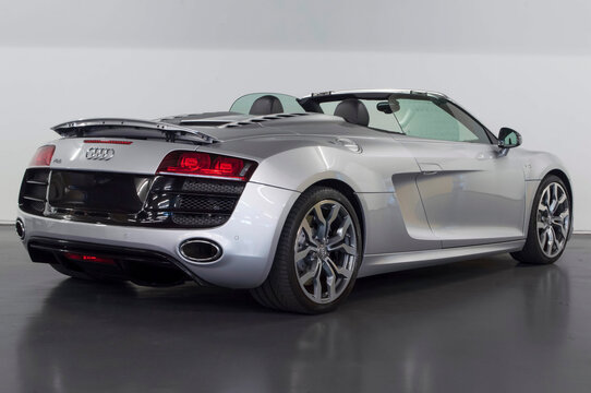 Silver Audi R8 V10 Spyder rear end view isolated on white background with roof open - High Resolution Image