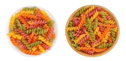 raw Fusilli colored pasta in bowl isolated on white background with full depth of field. Top view. Flat lay