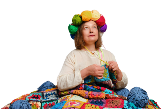 An adult woman knits a plaid crochet with balls of yarn on her head, isolated on white background - Powered by Adobe
