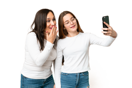 mother and daughter over isolated chroma key background making a selfie with the mobile