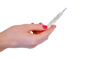 A woman's hand holds a thermometer over a table with pills, isolated on a white background