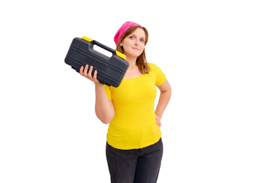 A young woman stands with a box of tools against a white wall, isolated on a white background