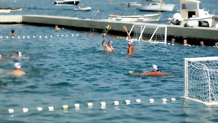 July, 2023, Kotor, Montenegro. Slow motion of water polo male team having open-air tournament on sea