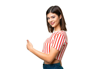 Young Russian woman over isolated chroma key background pointing back