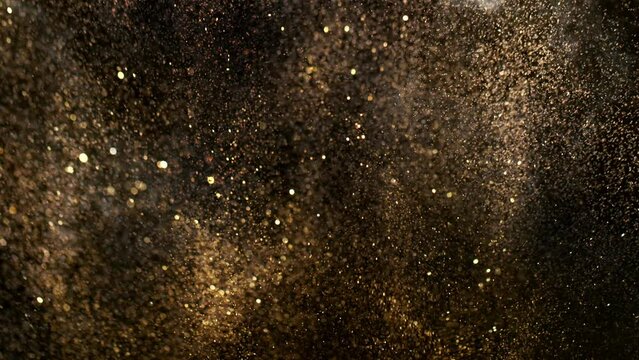 Super Slow Motion Shot of Festive Golden Glittering Background at 1000fps.