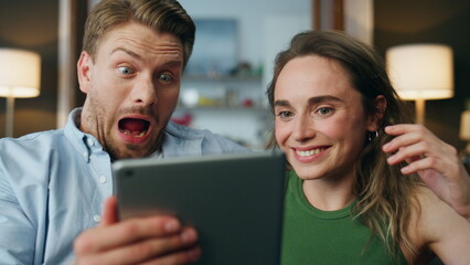 Amazed family watching tab screen at house zoom on. Shocked man opening mouth