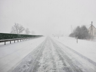 Drive in poor visibility conditions strong snow storm in Panevezys Region Lithuania - winter season