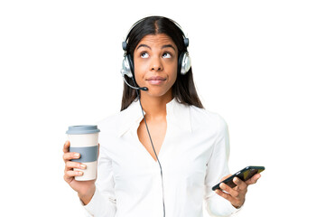 Telemarketer African American woman working with a headset over isolated chroma key background...