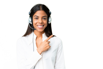 Telemarketer African American woman working with a headset over isolated chroma key background pointing to the side to present a product