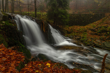 Ponikly waterfall with flood water after night rain in autumn morning