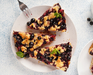 blackcurrant pie, three pieces, on a white round plate, no people, close-up, top view