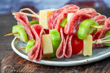 Mini Greek deli kebabs with salami, cheese, cherry tomatos and cucumber - party finger food