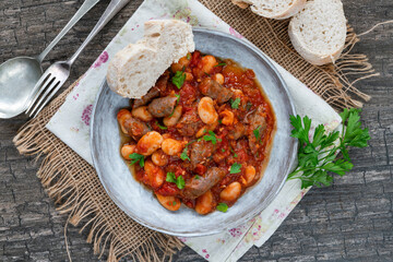Beef chipolatas and bean casserole with crusty bread