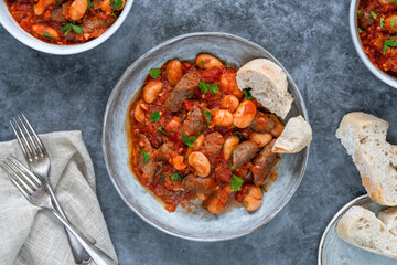 Beef chipolatas and bean casserole with crusty bread
