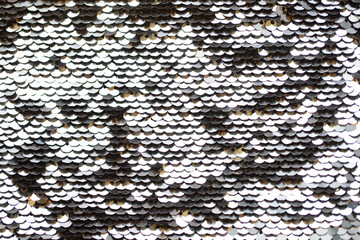 Naklejka premium Silver round shaped sequins attached to the fabric. Background texture