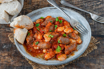 Beef chipolatas and bean casserole with crusty bread
