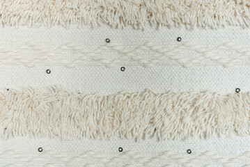 Off-white, woven textile background.