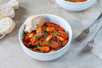 Beef chipolatas and bean casserole with crusty bread