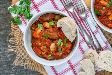 Beef chipolatas and bean casserole with crusty bread