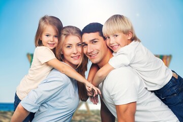 Happy family. young parents and children walk on the beach.