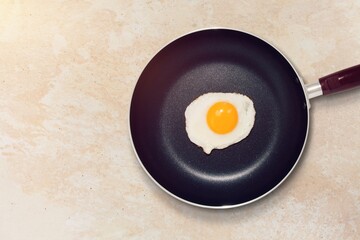 Tasty fried egg on pan on the desk