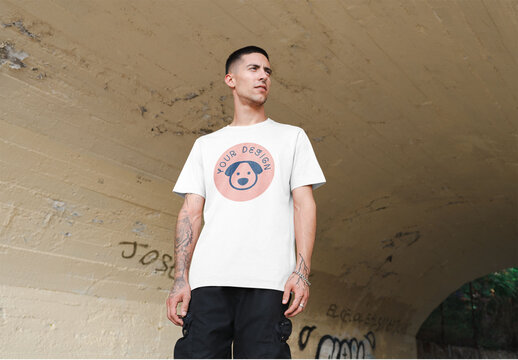 Mockup of man wearing t-shirt with customizable color and design in underpass