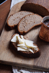 a loaf of black bread cut into pieces. Rye bread with butter.