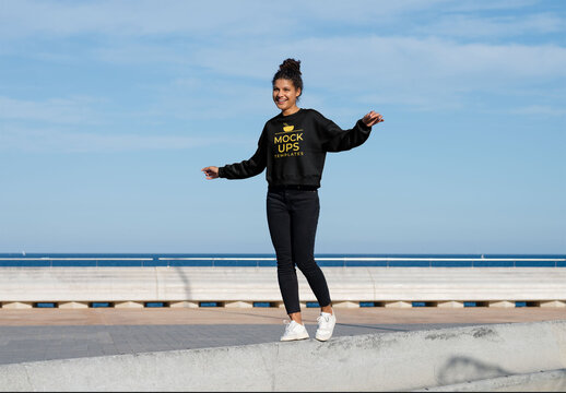 Mockup of carefree woman wearing customizable sweatshirt with arms out