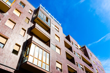 Modern residential building with tiled facade in a sunny day, Italy