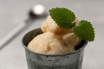 Lemon sorbet with mint leaf, refreshing ice cream, serving in a tin bucket
