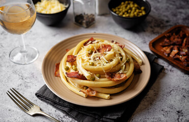 Bacon cheese green pea pasta in a plate