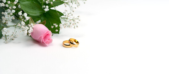 wedding rings with rose on white background