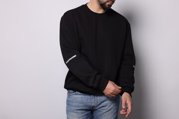 Man in stylish sweater on white background, closeup
