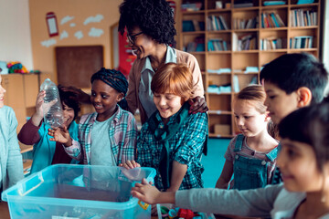 Children learning how to recycle plastic in elementary classroom