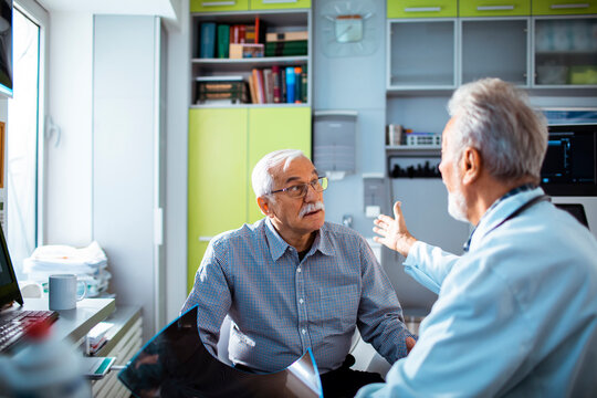 Senior Patient Discussing Health with Doctor in Clinic