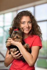 A young charming girl walking with a dog.