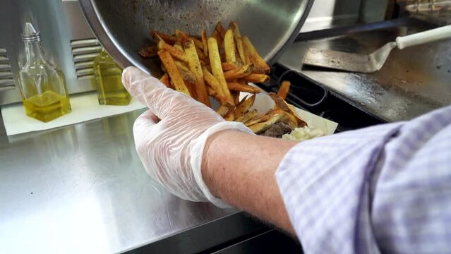 Chef serving fresh french fries