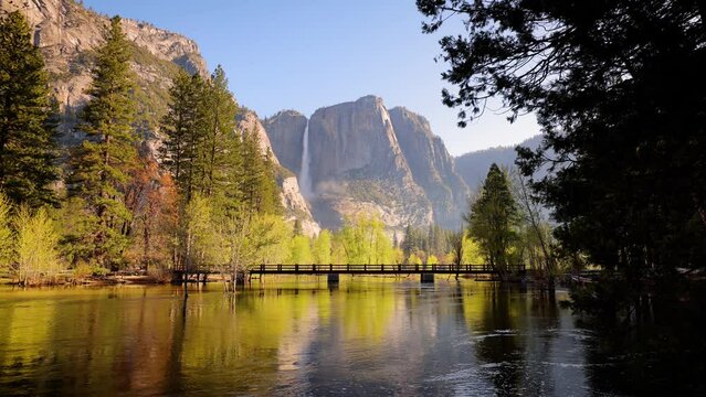 The Merced River as it runs through Yosemite National Park in California with Yosemite Falls in the background.