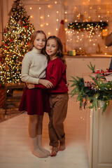  teenage sisters twins at home in the kitchen waiting for the New Year