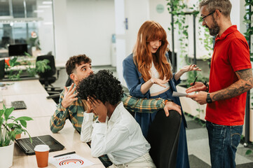 Multiracial business colleagues arguing during a meeting in an office