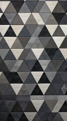 A repeating triangle pattern in shades of grey and black