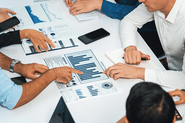 Analyst team utilizing BI Fintech to analyze financial data at table in meeting room. Businesspeople analyzing BI dashboard power on paper for business insight and strategic marketing planning.Prudent - obrazy, fototapety, plakaty
