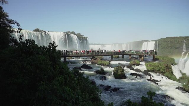 The Iguazu Falls are located at the border between Brazil and Argentina and are one of the seven wonders of the world, a populat ravel destination in the rainforest of south America.