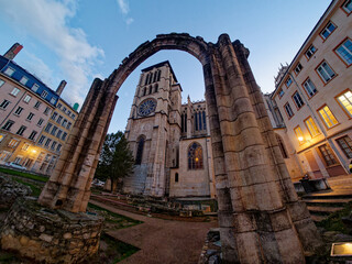 Evening view of Saint John cathedral in Lyon seen through the arch of the archeological garden, hemispherical wide angle, Lyon, France