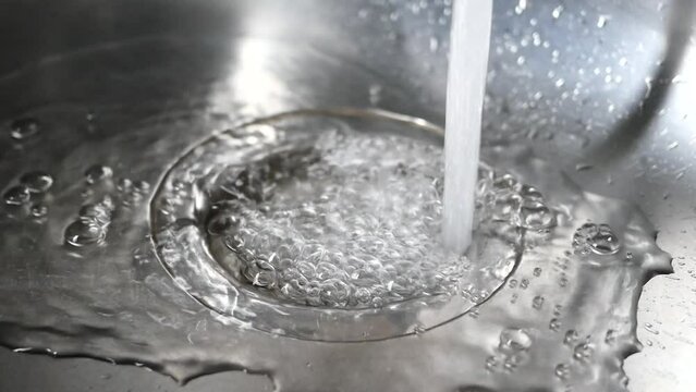 slow motion of water pouring from a faucet tap slow motion 